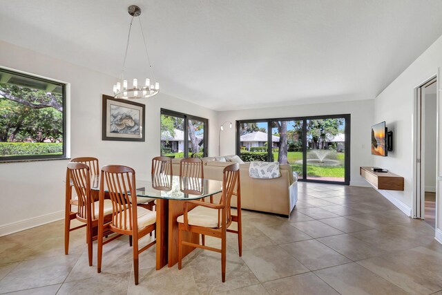 tiled dining space with a chandelier