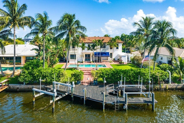 view of dock featuring a water view, boat lift, a balcony, and an outdoor pool