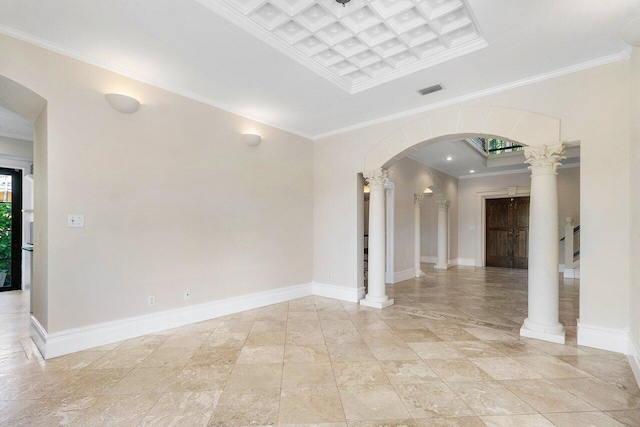 spare room featuring crown molding, arched walkways, decorative columns, and baseboards