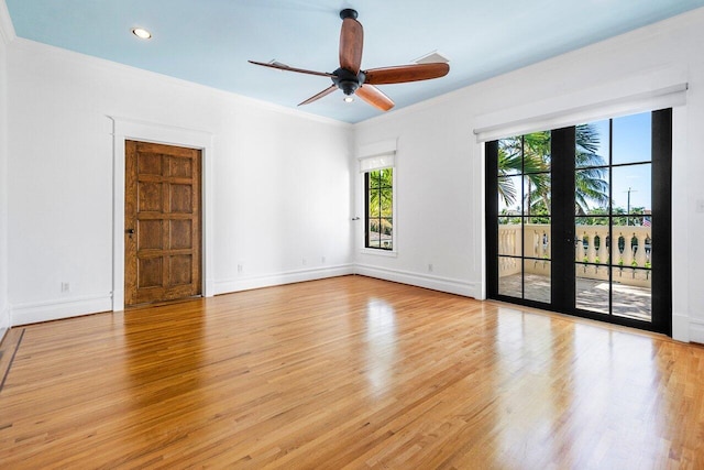 unfurnished room with baseboards, light wood finished floors, and crown molding