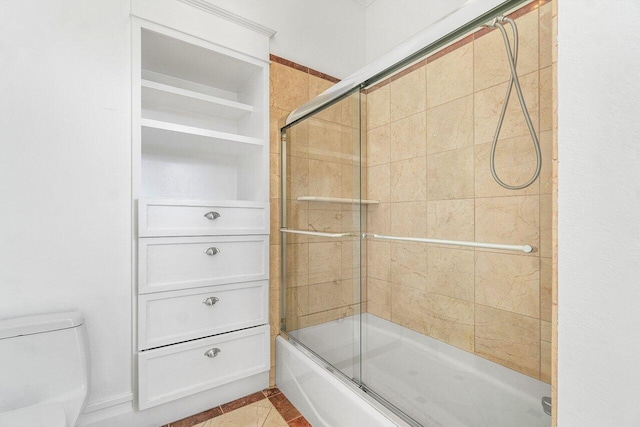 bathroom with enclosed tub / shower combo, toilet, and tile patterned floors