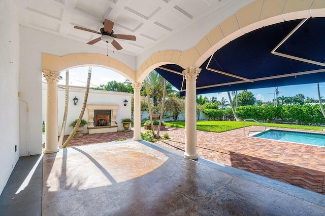 view of patio featuring an outdoor pool, exterior fireplace, and ceiling fan