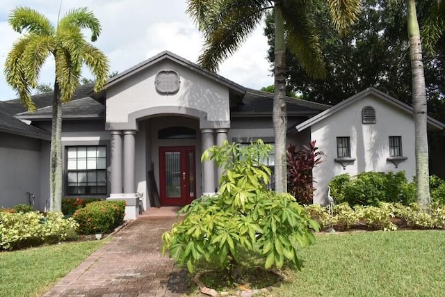 view of exterior entry with a yard