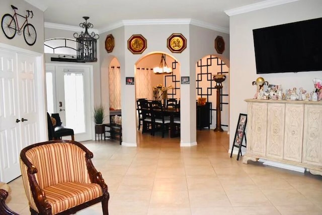 living area featuring a notable chandelier, light tile patterned floors, and ornamental molding