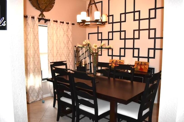 dining space with tile patterned floors and a notable chandelier