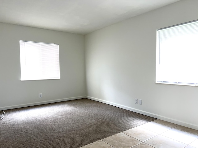 spare room with light colored carpet