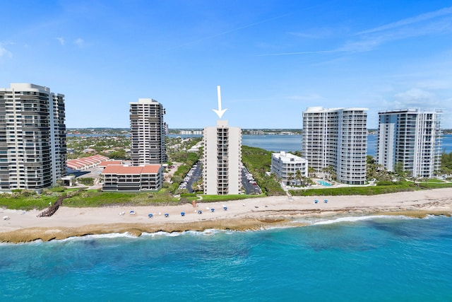 birds eye view of property with a beach view and a water view