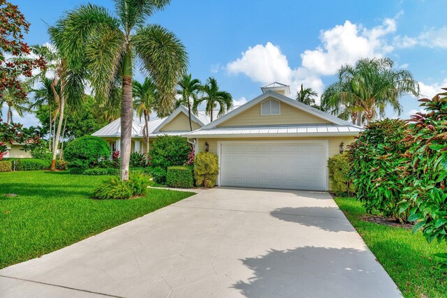 view of front of house with a garage and a front yard