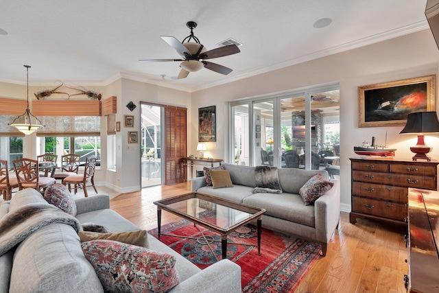 living room with ceiling fan, light hardwood / wood-style flooring, and crown molding