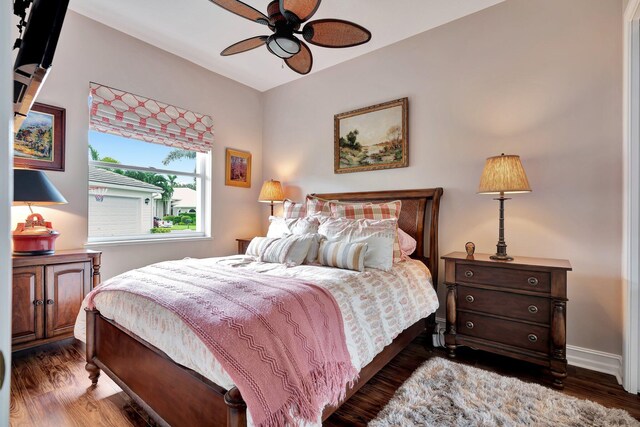 bedroom with ceiling fan and dark hardwood / wood-style floors