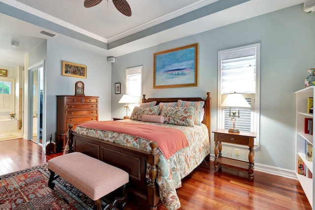 bedroom with hardwood / wood-style flooring, ensuite bath, and ceiling fan