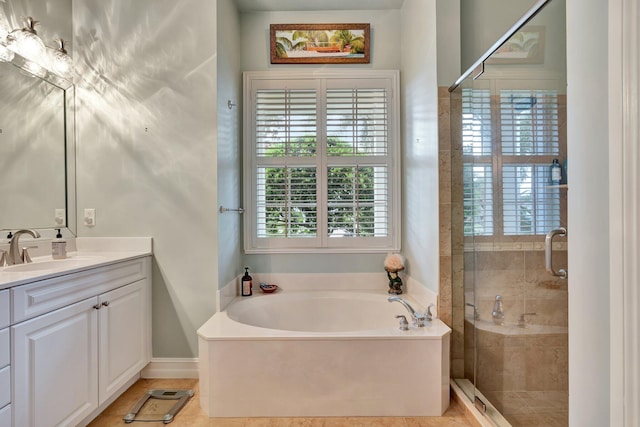 bathroom with plus walk in shower, vanity, and tile patterned floors