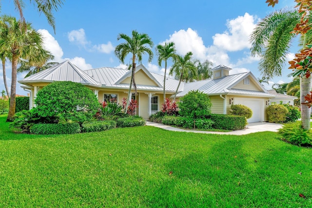 view of front of property featuring a garage and a front lawn