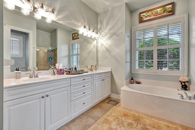 bathroom featuring tile patterned floors, separate shower and tub, and double vanity