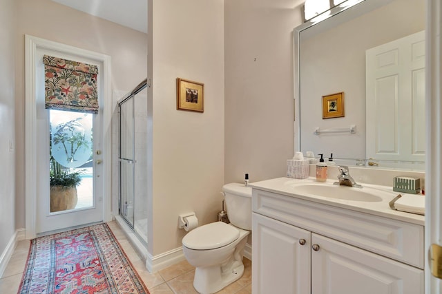 bathroom featuring tile patterned flooring, toilet, vanity, and a shower with shower door