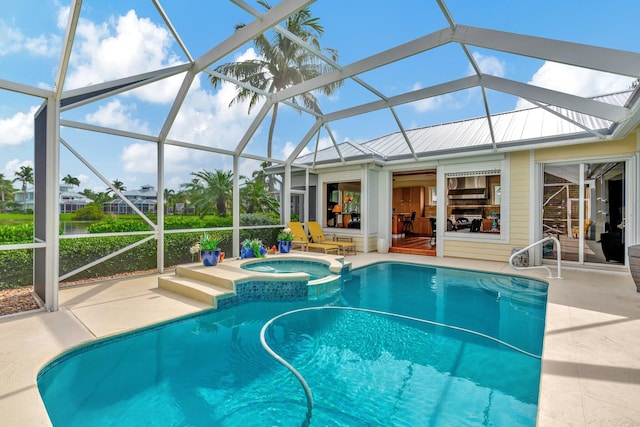 view of pool with a lanai, an in ground hot tub, and a patio