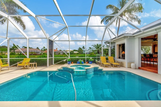 view of pool with ceiling fan, glass enclosure, an in ground hot tub, and a patio area