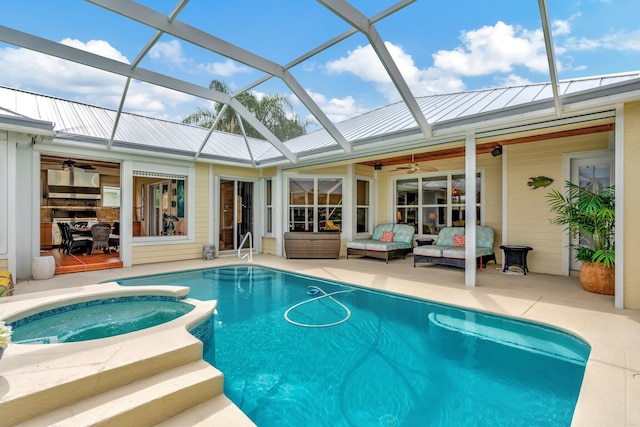 view of pool featuring ceiling fan, an in ground hot tub, a patio area, and a lanai