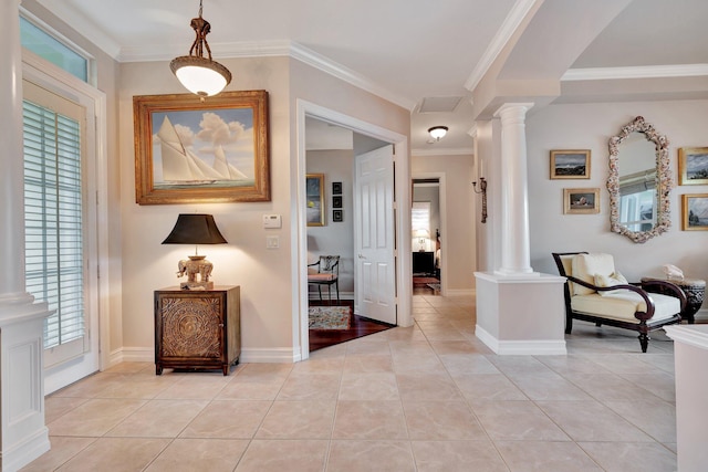 tiled entrance foyer featuring ornamental molding and ornate columns