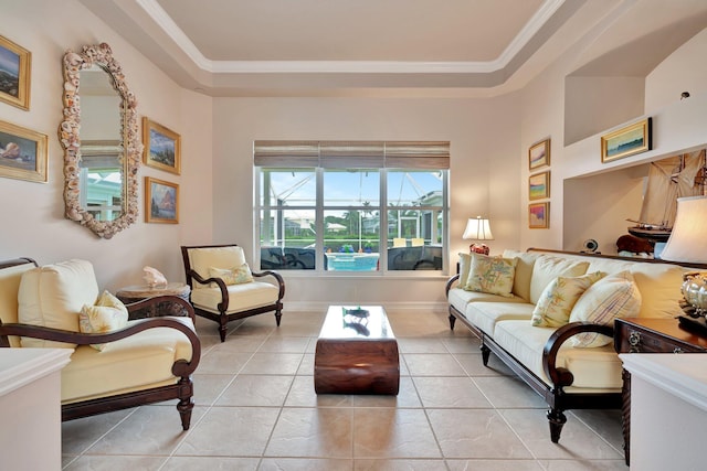 living room with a tray ceiling and light tile patterned flooring