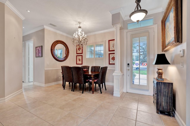 tiled dining space with an inviting chandelier, decorative columns, and ornamental molding