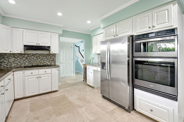 kitchen with stainless steel appliances, tasteful backsplash, white cabinetry, and under cabinet range hood