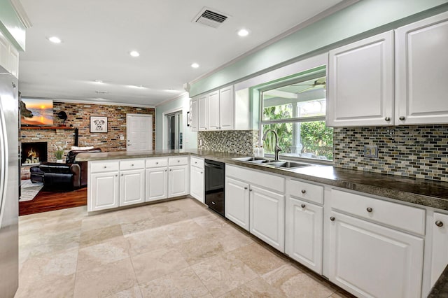 kitchen featuring black dishwasher, visible vents, ornamental molding, a peninsula, and a sink