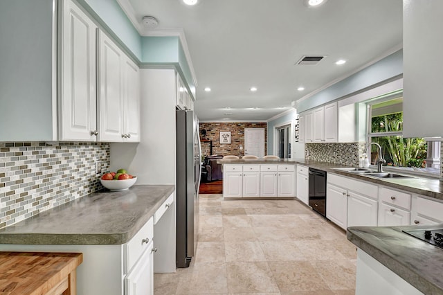 kitchen with visible vents, dishwasher, freestanding refrigerator, a peninsula, and crown molding