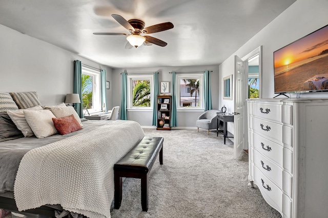 carpeted bedroom featuring ceiling fan and baseboards