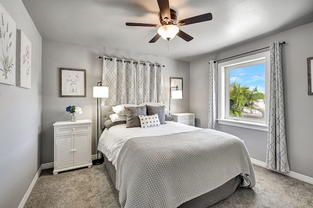 carpeted bedroom featuring ceiling fan and baseboards