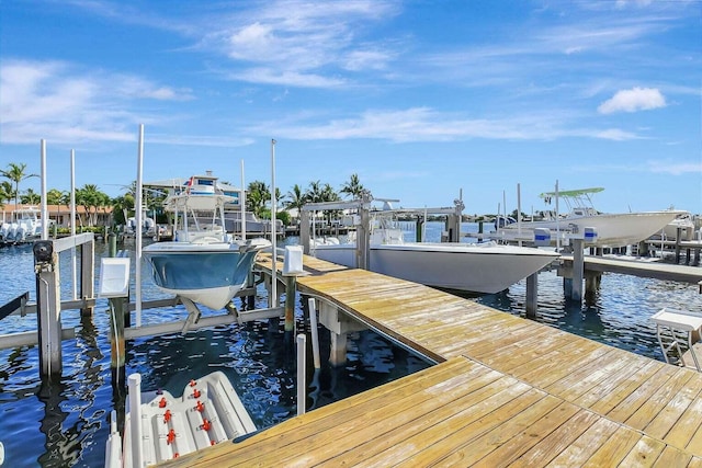 dock area with a water view and boat lift