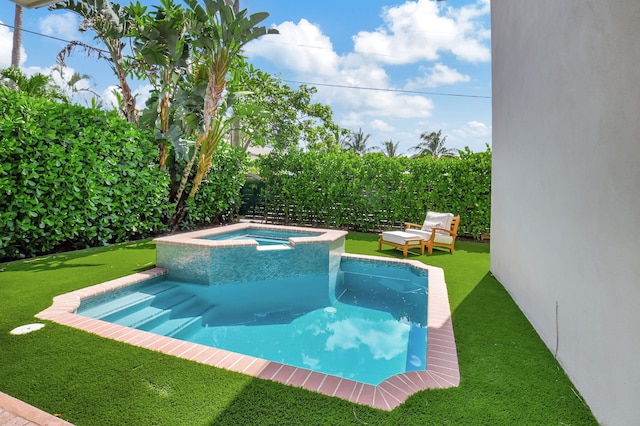 view of swimming pool with a yard and a pool with connected hot tub