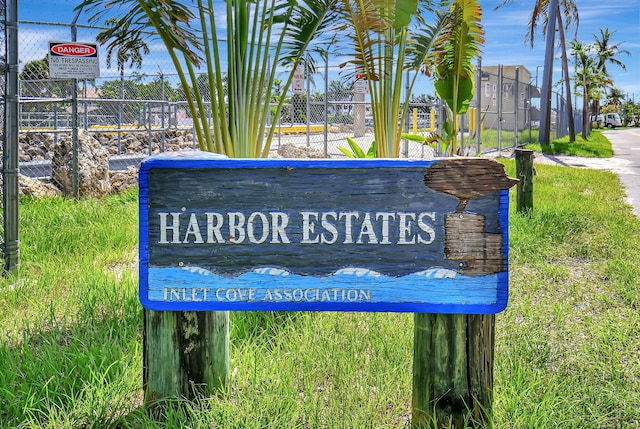 community / neighborhood sign with fence