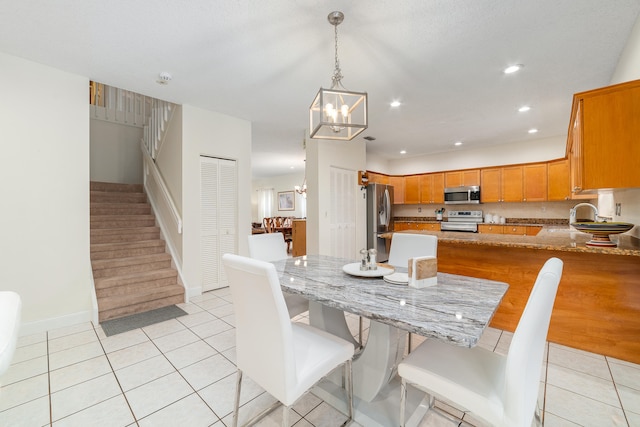 tiled dining area featuring a notable chandelier