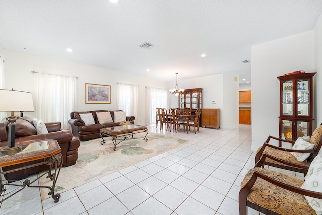 living room featuring light tile patterned floors, a chandelier, and a healthy amount of sunlight