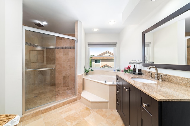 bathroom with plus walk in shower, tile patterned flooring, and vanity