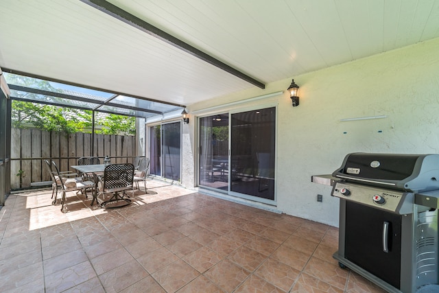 view of patio featuring grilling area and a lanai