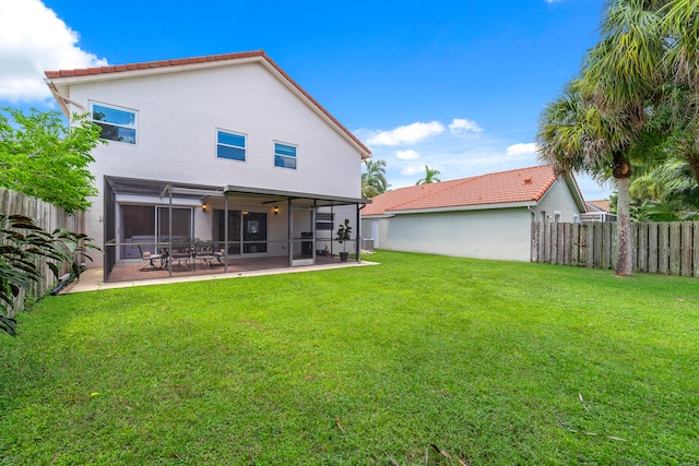 back of house featuring a patio area and a yard