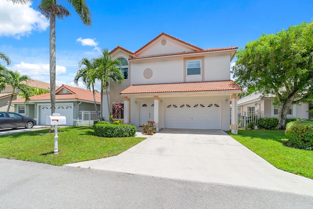 mediterranean / spanish house featuring a front lawn and a garage