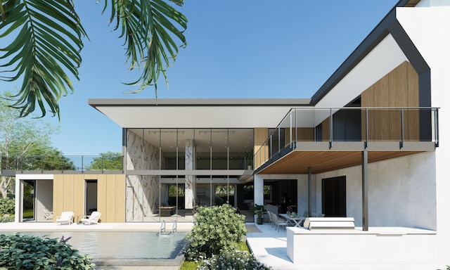 back of house with a patio area and a balcony