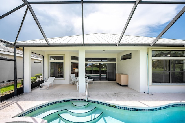 pool with glass enclosure and a patio