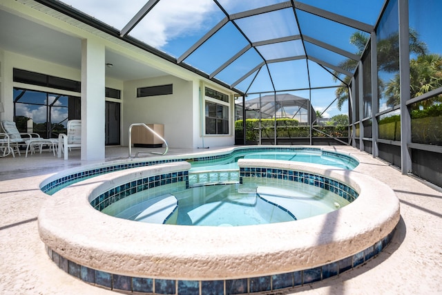 view of pool with a pool with connected hot tub, a lanai, and a patio