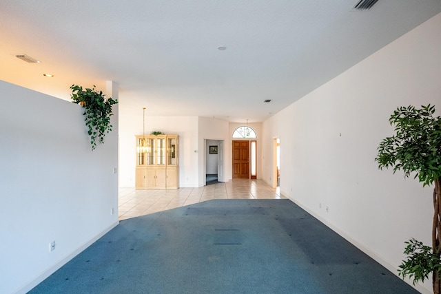 unfurnished room with light tile patterned floors, baseboards, and visible vents