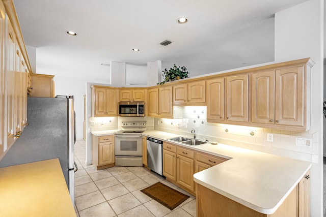 kitchen with backsplash, sink, appliances with stainless steel finishes, light brown cabinets, and light tile patterned floors