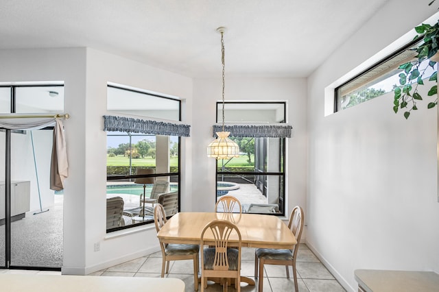 dining space with light tile patterned flooring and baseboards