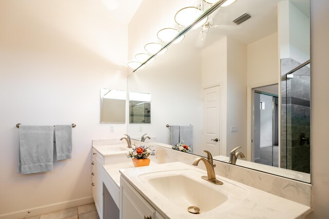 bathroom with tile patterned flooring, double sink vanity, and an enclosed shower