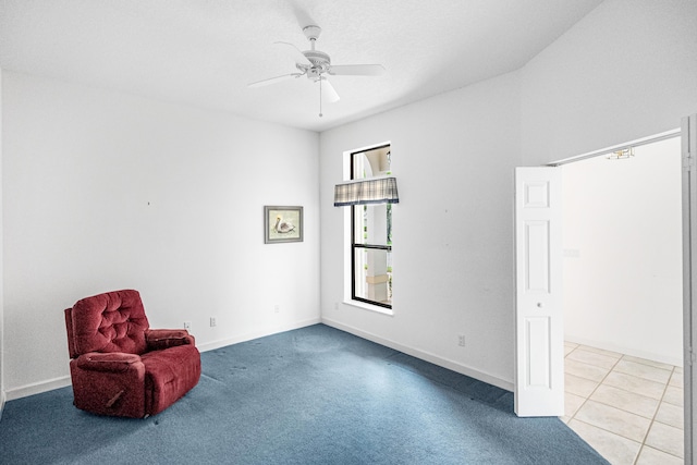 unfurnished room with light colored carpet, ceiling fan, and baseboards