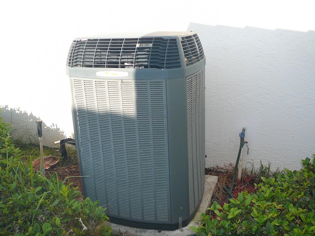 details with central air condition unit and stucco siding