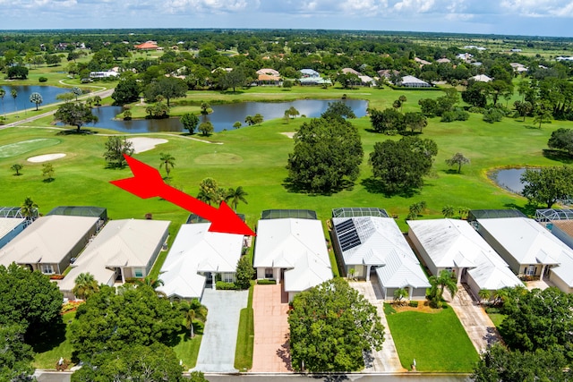 drone / aerial view featuring a residential view, a water view, and golf course view