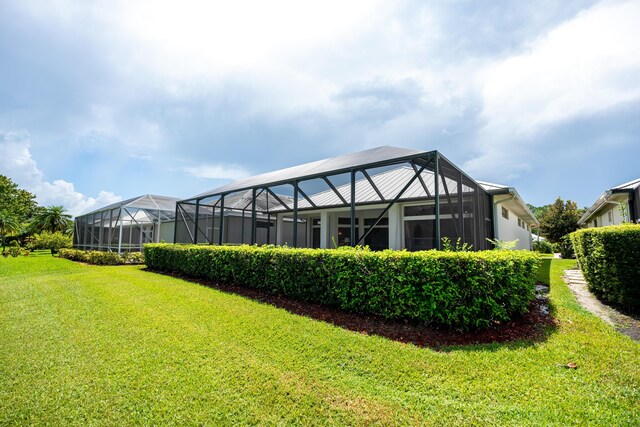 exterior space with a lawn and a lanai